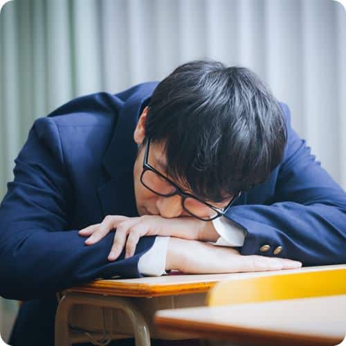a man sleeping on his desk
