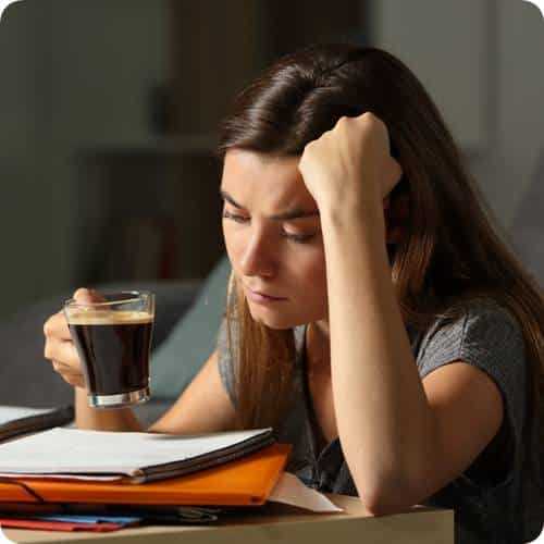 a woman holding a cup of coffee